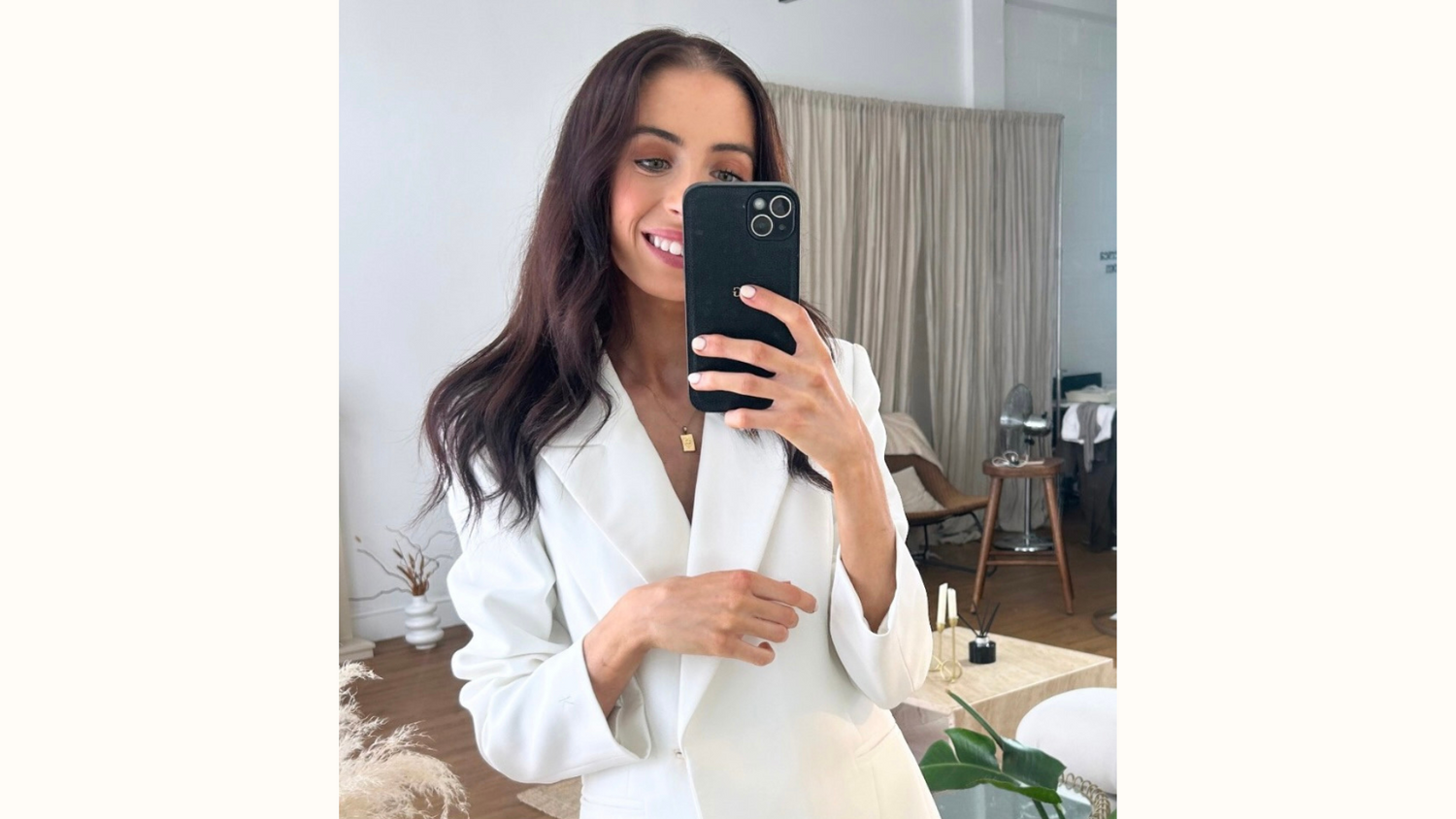 KUOTES founder wearing The KUOTES Blazer – a luxury white tailored women’s blazer designed with minimalist elegance and empowerment in mind.